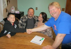 Team owner Jim Howe (right) welcomes Eli Fox (left) to the Jim Howe Motorsports team for 2014 as parents Jamie (second from left) and Morgan Fox look on (Photo: Jim Howe Motorsports)