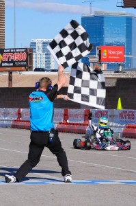 Christchurch karter Matthew Hamilton (#9NZ blue and yellow helmet ) greets the chequered flag to win the S4 Masters Stock Moto class at the 17th annual SKUSA SuperNationals meeting in Las Vegas last year (Photo: Fast Company/Ash Budd)