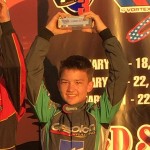 Nick Brueckner stands on the podium in the third position during his first Rok Cup USA event
