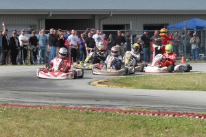 Scott Dixon completes last lap, last corner pass to win the Dan Wheldon Memorial ProAm Karting Challenge (Photo: EKN)