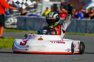 Hunter Fox with his fist held high after winning the 4 kart race to the line in Briggs Junior
