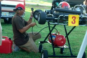 Oliver's father Tony working on his kart during the early years of karting
